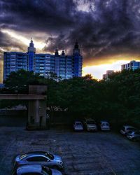 View of city against cloudy sky at sunset