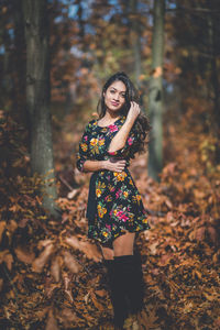 Portrait of woman standing in forest