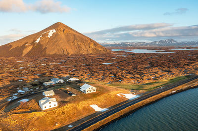 Sertingofljget mountain, iceland with expedition-style research buildings, coastal road.
