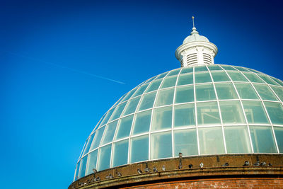 Low angle view of building against blue sky