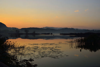 Scenic view of lake against sky during sunset