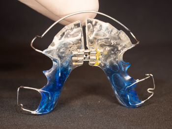 Close-up of electric lamp on table against black background