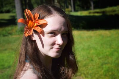 Portrait of woman with flower in hair