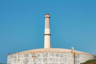 Low angle view of chimney against clear blue sky