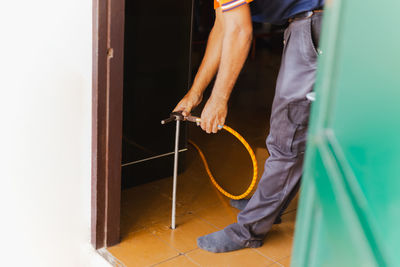 Termite control worker using chemicals into soil to prevent underground termites.