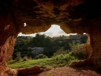 Scenic view of mountain seen through cave