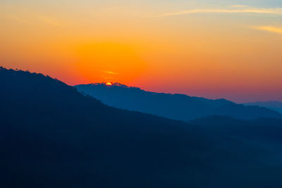 Scenic view of silhouette mountains against sky during sunset