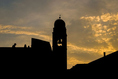 Low angle view of silhouette building against sky during sunset