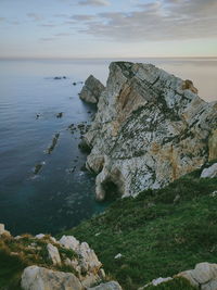 Scenic view of rocks in sea against sky