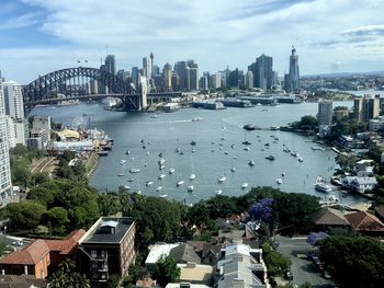 High angle view of city by sea against sky