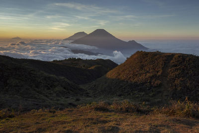 Scenic view of mountain range against sky during sunset