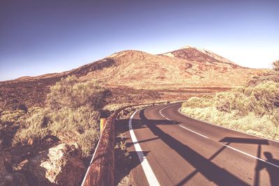 Scenic view of mountain road against clear sky