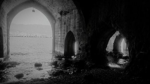 Arch bridge over sea in old building