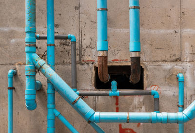 Close-up of blue pipe against wall