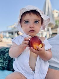 Innocent child eating fruit on holiday 