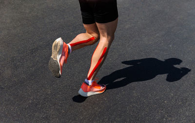 Low section of person running on road