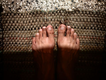 Low section of man standing on doormat