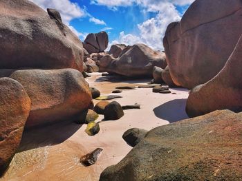 Panoramic view of rocks on beach against sky