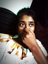 Close-up portrait of young woman at home