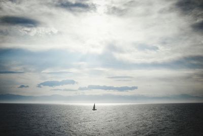 Boat on sea against dramatic sky