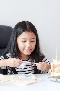 Portrait of happy girl on table