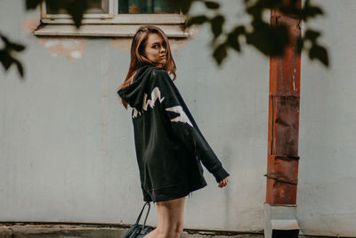 Portrait of beautiful young woman standing outdoors