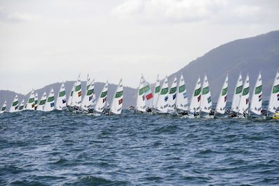 Sailboats sailing in sea against sky