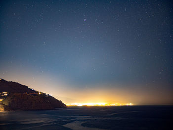 Scenic view of sea against sky at night