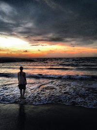 Silhouette of people on beach at sunset