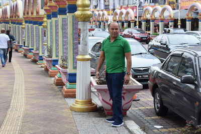 Full length portrait of man standing on street