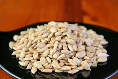 Closeup pile of roasted sunflower seeds in a black saucer