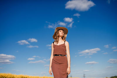 Rapeseed field, yellow field, forest, spring day, romantic date, blue sky, straw hat, hat with brim