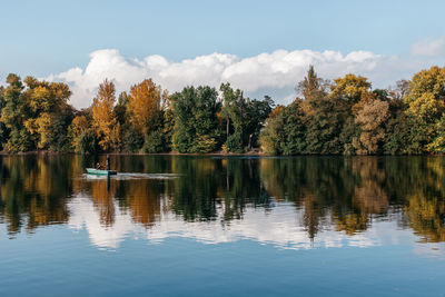 Scenic view of lake by trees against sky