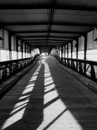 Empty footbridge during sunny day