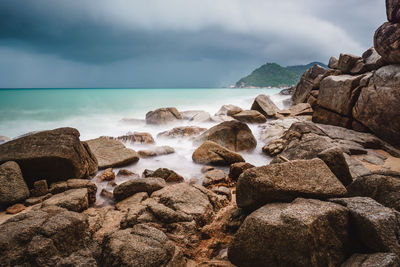 Rocks on beach against sky