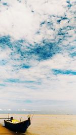 Fishing boat on sea against sky