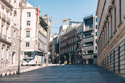 Footpath amidst buildings in city