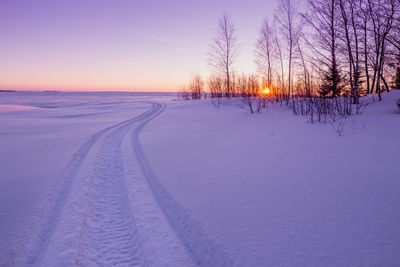 Scenic view of lake against clear sky during sunset