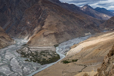 High angle view of mountains against cloudy sky