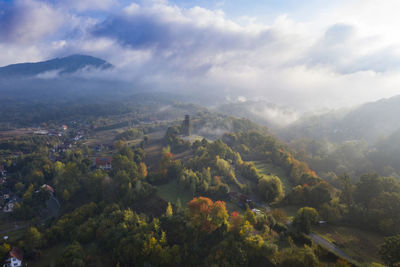 Aerial view of mountains against cloudy sky