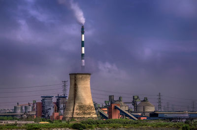 Low angle view of illuminated building against cloudy sky