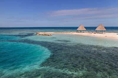 Scenic view of beach against blue sky