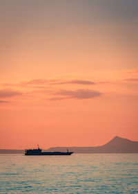 Silhouette boat on sea against sky during sunset