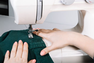 Cropped hands sewing machine