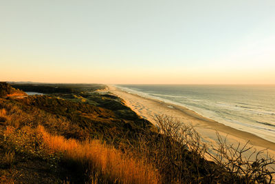 Scenic view of sea against clear sky during sunset