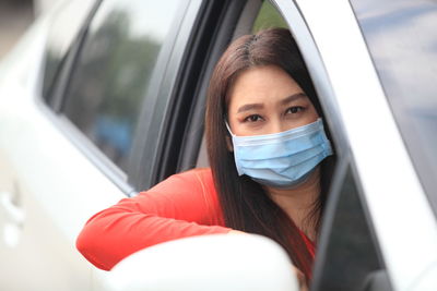 Portrait of young woman in car