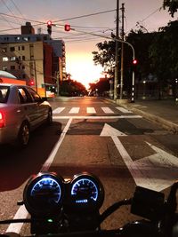 Cars on road at sunset