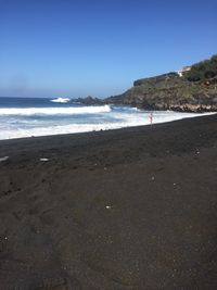 Scenic view of beach against clear sky