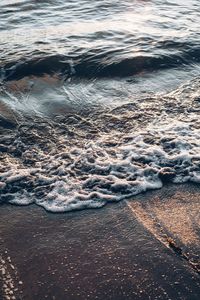 High angle view of waves rushing towards shore