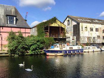 Boats in river with buildings in background